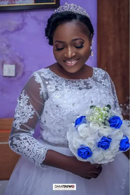 Smiling bride with a blue and white bouquet