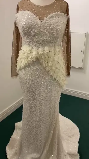 The gown with its floral sash, made in the UK
